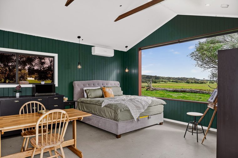 The studio interior with reverse-cycle air conditioning above the bed