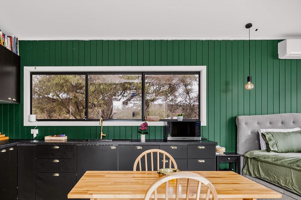 The studio — kitchen, dining and bed in one room