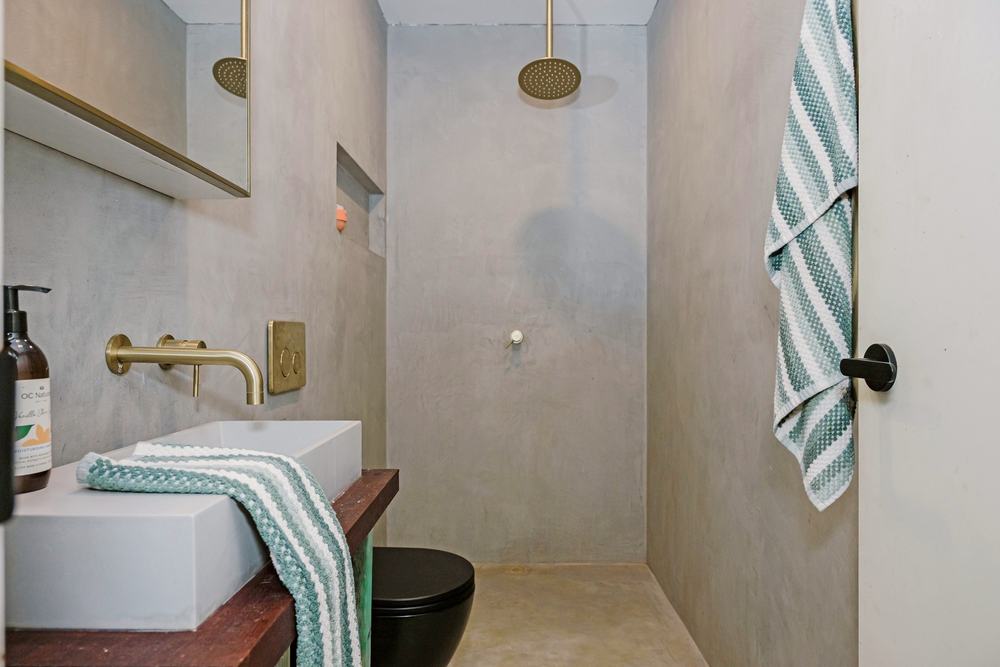 Micro-cement ensuite with rain shower