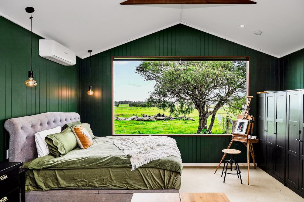 The bed and easel beside the window